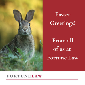 Photo of a brown rabbit sitting up on hind legs in the grass with a yellow background, next to the words "Easter Greetings! From all at Fortune Law" all above the firm logo, Fortune Law the law firm for entrepreneurs, founders and startups.